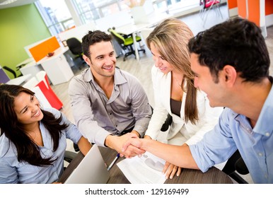 Business People Closing A Deal And Handshaking At The Office