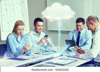 Business, People, Cloud Computing And Technology Concept - Smiling Business Team With Smartphones, Tablet Pc Computers Working In Office