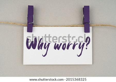 Business and people concept. On a gray background, a business card with the inscription - why worry