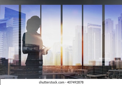 Business And People Concept - Silhouette Of Woman With Tablet Pc Over Office Window Background Over Double Exposure Office And City Background