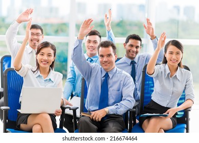 Business People At The Conference Raising Hands To Answer A Question