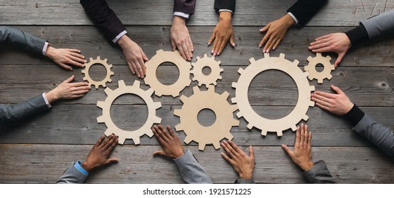 Business People Connect Golden Gear Together At Meeting Table, Success Cooperation Teamwork Concept