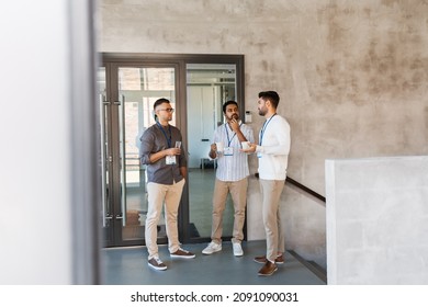 Business, People And Corporate Concept - Businessmen With Name Tags Drinking Coffee And Water At Office