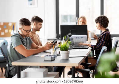 business, people and corporate concept - team of startuppers or ui designers working at office - Shutterstock ID 1803698566