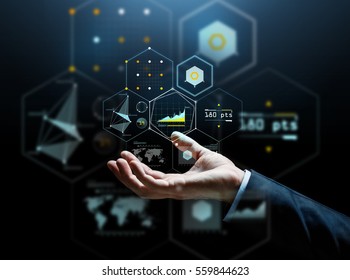 business, people, cyberspace and future technology concept - businessman hand with virtual hologram of charts and projections over dark background - Shutterstock ID 559844623