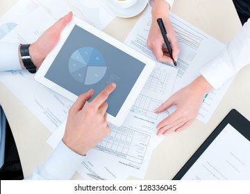 Business People Developing A Business Project And Analyzing Market Data Information On A Modern Digital Tablet Computer. Top View Photo Shoot.