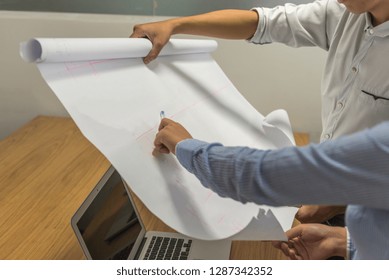 Business people discussing about the plan research paper - Shutterstock ID 1287342352