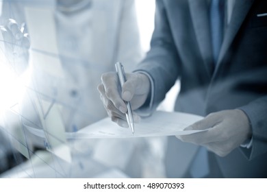 Business people discussing the charts and graphs showing the results of their successful teamwork - Shutterstock ID 489070393