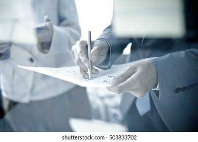 Business people discussing the charts and graphs showing the results of their successful teamwork - Shutterstock ID 503833702