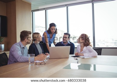 Business people discussing at desk during metting in board room