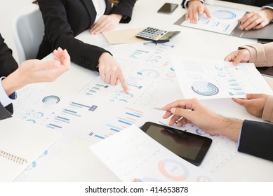Business people discussing documents at the meeting - brainstorming concept - Shutterstock ID 414653878