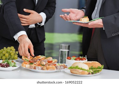 Business people discussing at the lunch buffet