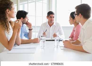 Business People Discussing In Meeting At Conference Table In Office