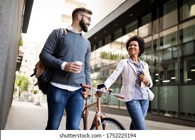 Business people discussing and smiling while walking together outdoor