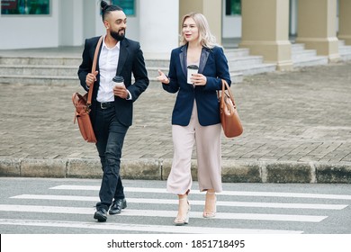 Business People Drinking Take Out Coffee When Crossing Road And Discussing News