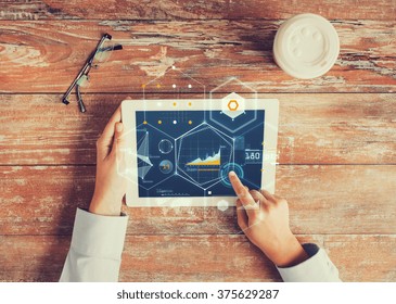 business, people, economics, statistics and technology concept - close up of hands pointing finger to tablet pc computer screen with virtual graph projection coffee cup and eyeglasses on table