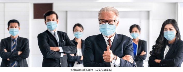 Business people , employees and office worker wearing ppe face mask while standing in reopen office . Concept of business reopen by people work with face mask wearing for protection . - Powered by Shutterstock