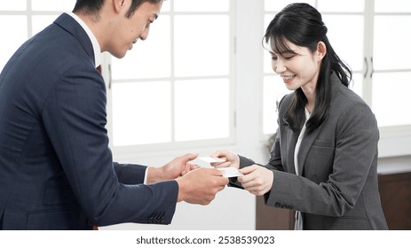 Business people exchanging business cards - Powered by Shutterstock