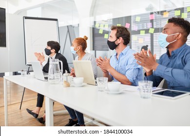 Business People With Face Masks Because Of Covid-19 Clap In A Training Course