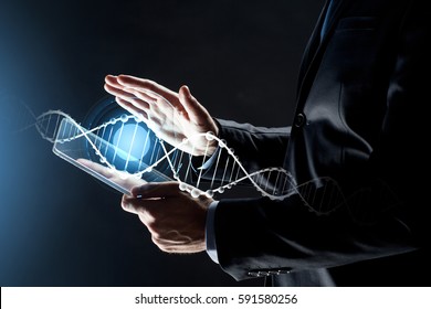 business, people and future technology concept - close up of businessman hands with transparent tablet pc computer and dna molecule projection over black background