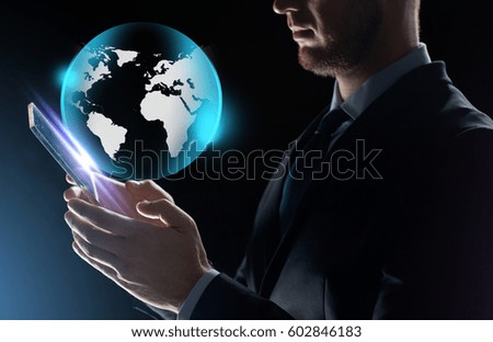 business, people and future technology concept - close up of businessman with transparent tablet pc computer and earth projection over black background