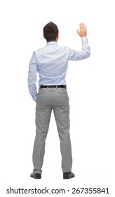 Business, People, Gesture And Office Concept - Businessman Waving Hand Or Touching Something Imaginary From Back