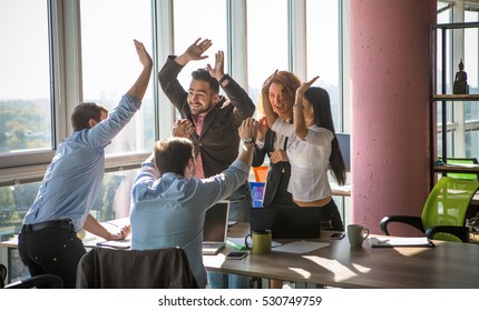 Business People Giving Five After Dealing And Signing Contract Or Agreement With Partners Abroad. Colleagues Showing Team Work In Office Interior.