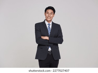 business, people good looking in studio. Asian businessman in grey suit confident with crossed arms on white background.