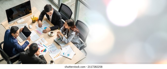 Business people group meeting shot from top widen view in office . Profession businesswomen, businessmen and office workers working in team conference with project planning document on meeting table . - Shutterstock ID 2117282258