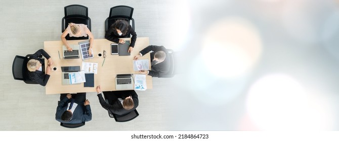 Business people group meeting shot from top widen view in office . Profession businesswomen, businessmen and office workers working in team conference with project planning document on meeting table .