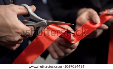 Business people hands cutting red ribbon close-up, new project, opening ceremony, stock footage