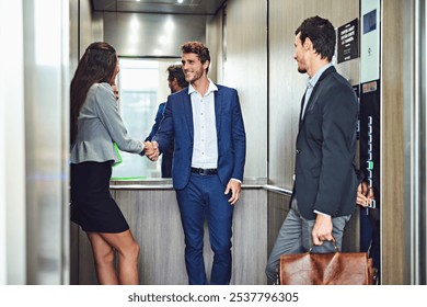 Business people, handshake and elevator with team for meeting, introduction or welcome in office building. Happy, businessman or employees shaking hands for greeting or collaboration in company lift - Powered by Shutterstock