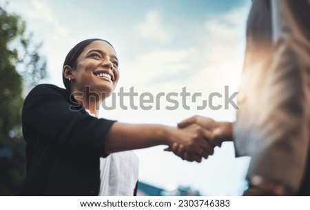 Business people, handshake and meeting in city for partnership, greeting or introduction and welcome outdoors. Happy woman with smile shaking hands for b2b, collaboration or agreement in deal outside