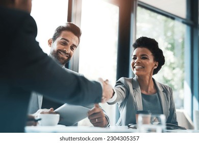 Business people, handshake and meeting for partnership, teamwork or collaboration in boardroom at office. Happy woman shaking hands in team recruiting, introduction or b2b agreement at the workplace - Shutterstock ID 2304305357