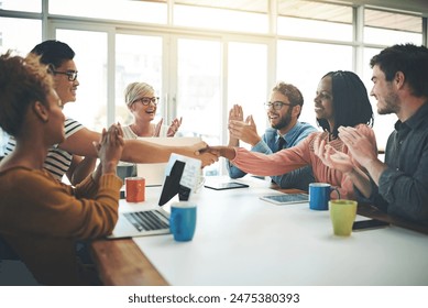 Business people, handshake and meeting with team in applause for promotion, congratulations or deal at office. Group of employees shaking hands for agreement, collaboration or winning at workplace - Powered by Shutterstock