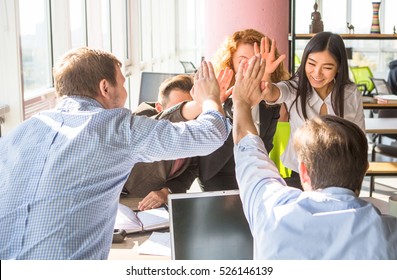 Business People Happy Showing Team Work And Giving Five After Signing Agreement Or Contract With Foreign Partners In Office Interior. Happy People Smiling. Agreement Or Contract Concept.