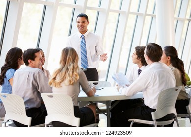 Business People Having Board Meeting In Modern Office