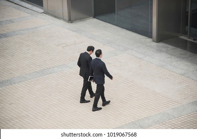 Business People Having Conversation And Walking In Office Building. High Angle View