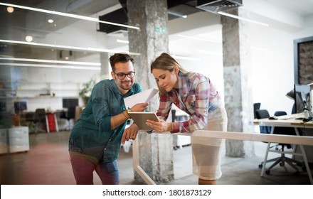 Business people having fun and chatting at workplace office - Shutterstock ID 1801873129