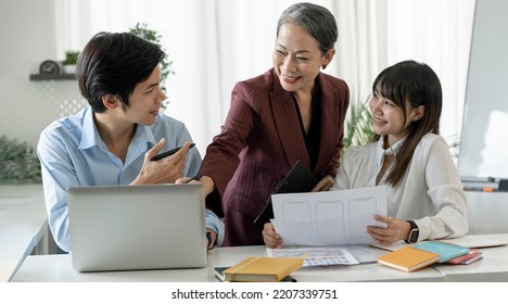 Business People Having A Business Meeting. Happy Diverse Asian Business Team Young And Old Workers Talking Brainstorming On Project In Office