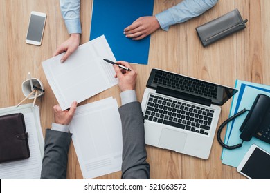 Business People Having A Meeting In The Office, The Man Is Showing To The Woman A Contract And Explaining It, Top View