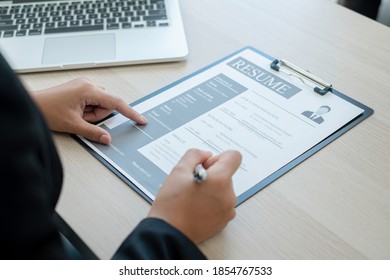 Business people hold a resume and talk to job applicants for job interviews about careers and Her personal history in the company. Recruitment concepts.