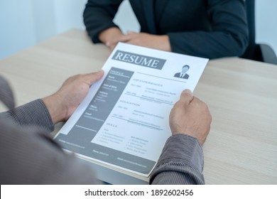 Business people hold a resume and talk to job applicants for job interviews about careers and Her personal history in the company. Recruitment concepts.