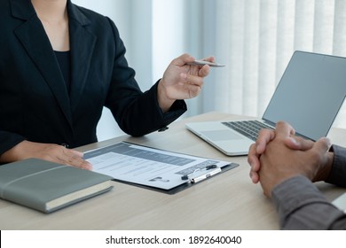 Business people hold a resume and talk to job applicants for job interviews about careers and Her personal history in the company. Recruitment concepts. - Shutterstock ID 1892640040