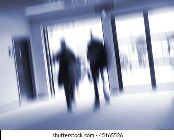 Business people hurrying to the next appointment. Zoom blur - space for text.