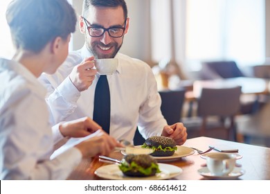 Business people interacting by lunch in restaurant