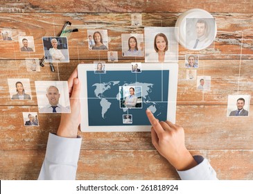business, people, international communication, headhunting and technology concept - close up of hands pointing finger to tablet pc computer screen with world map and internet contacts network on table
