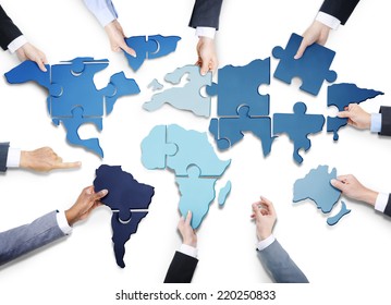 Business People with Jigsaw Puzzle Forming World Map - Shutterstock ID 220250833