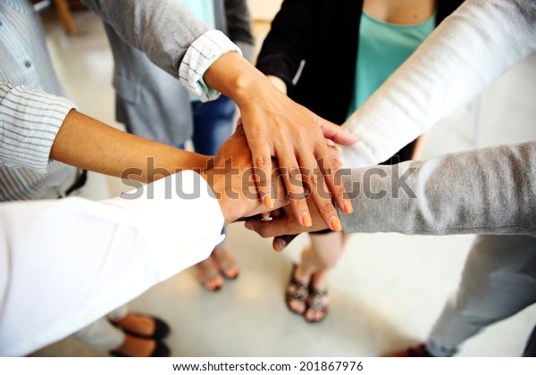 people joining hands around