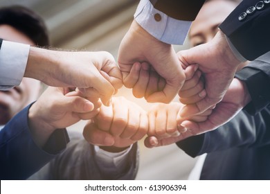 Business People Joining Hands Showing Teamwork and Support.